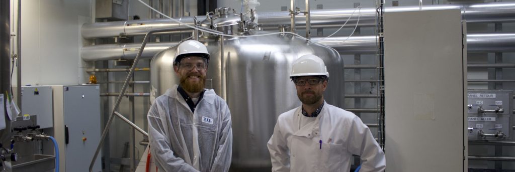 Scott Kennedy standing in front of the SAS Pivert 3000L reactor in France