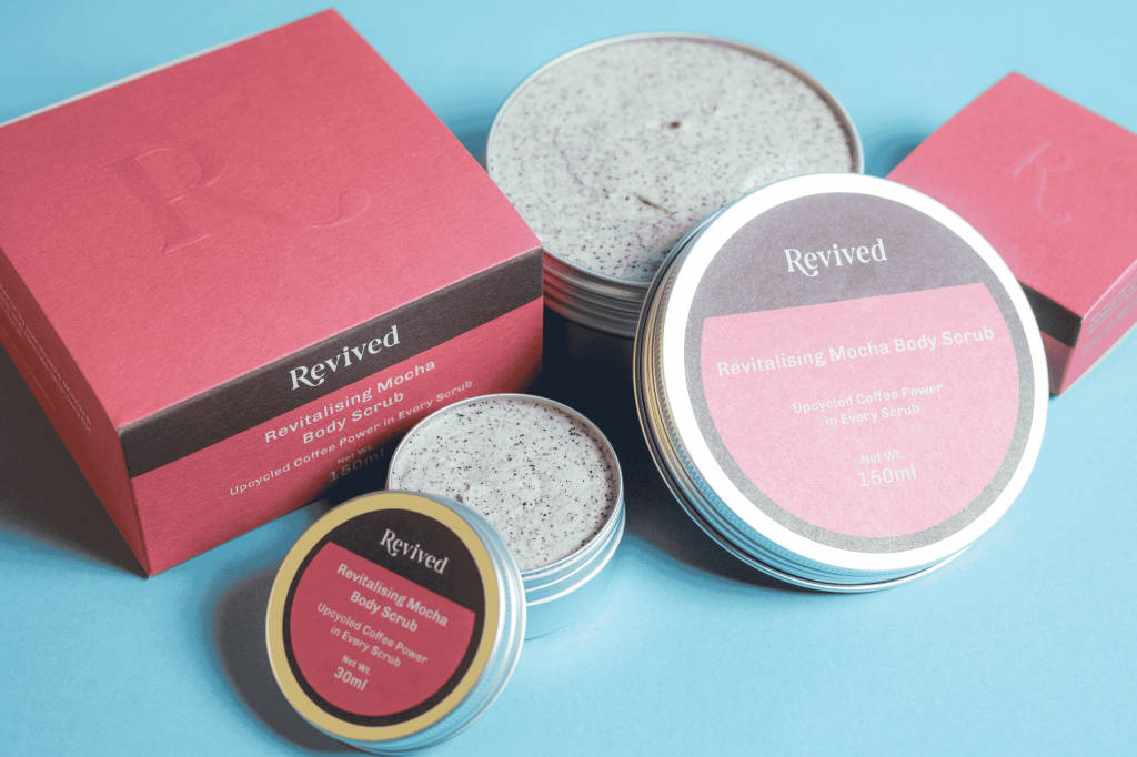 close up of the 150ml and 30ml body scrubs in open tins