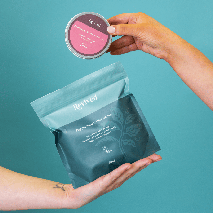 two hands holding the two different revived body scrubs